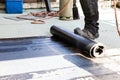 Flat roof installation. Heating and melting bitumen roofing felt Royalty Free Stock Photo