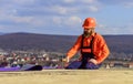 Flat roof installation. Roofer constructing new roof. Estimate materials requirements for projects. Install roofing Royalty Free Stock Photo