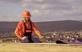 Flat roof installation. Roofer constructing new roof. Estimate materials requirements for projects. Install roofing Royalty Free Stock Photo