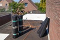 Flat roof with rolls of white roofing felt or bitumen Royalty Free Stock Photo