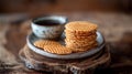 Flat round waffles on plates with a mug of coffee, everything stands on a wooden stand.