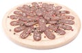 Flat sausage on rounder wooden board, isolated Royalty Free Stock Photo