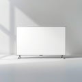 Flat screen television with a white screen on a white surface in a white room with light shining on it Royalty Free Stock Photo