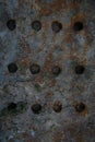 Flat sheet of rusty iron cast iron with horizontal rows of round holes. Highly Detailed Grunge Metal Background Texture.