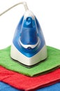 Flat smoothing iron on coloured towels Royalty Free Stock Photo