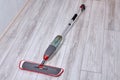 Flat spray mop with water spraying of wooden floor cleaner with trigger spray on handle and microfiber pad. Royalty Free Stock Photo