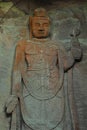 Flat standing Buddha carved from rock