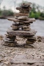 Flat stones on the riverside, rock balancing, vertical