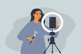 Flat style illustration on the theme of blogging, shooting video content. girl beauty-blogger doing makeup