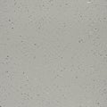 A flat surface of speckled concrete with a gray color. Small, irregular dark and light sp Royalty Free Stock Photo