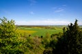 The flat Swedish farmlands with green fields and yellow rapeseed canola fields is seen from the hill Billebjer in SkÃÂ¥ne, the