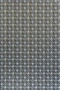 Flat textile with dark gray background, yellow lurex, and houndstooth pattern Royalty Free Stock Photo