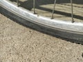 Flat tire on a bicycle. Wheel flattened on asphalt. The hole in the rubber tire. Aluminum Bicycle Wheel Frame