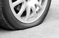 Flat tire on the car. Silver forged wheel. Close up Royalty Free Stock Photo