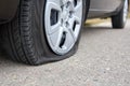 Flat tire of a car, trouble on the road Royalty Free Stock Photo