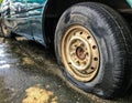 Flat Tire of an old car on the road Royalty Free Stock Photo