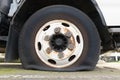 Flat truck tire on axel with rust on wheel hub