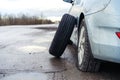 Flat tyre on road. Car tire leak because of nail pounding Royalty Free Stock Photo