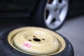 Flat tyre on road. Car tire leak because of nail pounding. Wheel damage on a road. Royalty Free Stock Photo