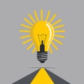 Flat vector light bulb with bold yellow rays, floating above a path, symbolizing direction. Royalty Free Stock Photo