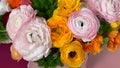 Flat view bright colorful pink yellow orange persian asian buttercup ranunculus asiaticus flowers in round box Royalty Free Stock Photo