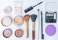 Flat view on cosmetics, makeup and brushes on white background