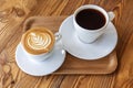 Flat white or cappuccino and filter coffee in white cups on wooden table. Different coffee styles, morning drink in cafe on small Royalty Free Stock Photo