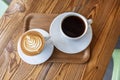 Flat white or cappuccino and filter coffee in white cups on wooden table. Different coffee styles, morning drink in cafe on small Royalty Free Stock Photo