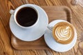 Flat white or cappuccino and filter coffee in white cups on wooden table. Different coffee styles, morning drink in cafe on small Royalty Free Stock Photo