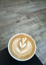 Flat white coffee in a cafe latte art on wooden floor