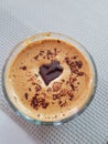 Flat white coffee with dark chocolate piece