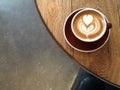 Flat white latte art on a wooden table from above