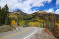 A flatbed pickup truck on mountain highway in Colorado Rocky Mountains during fall peak colors