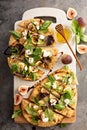 Flatbread pizza with figs, cheese and salad leaves
