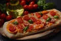 Flatbread pizza garnished with fresh cherry tomatoes, basil, cheese and olive oil on wooden pizza board.