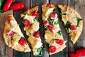 Flatbread pizza with mozzarella, tomatoes, spinach, artichokes, over rustic wood Royalty Free Stock Photo