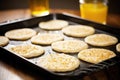 flatbread rounds being dropped onto a baking tray Royalty Free Stock Photo