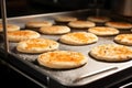 flatbread rounds being dropped onto a baking tray Royalty Free Stock Photo