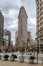 Flatiron Building New York City with People and Plants in forefront Royalty Free Stock Photo