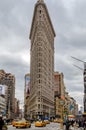 Flatiron Building New York City with street and yellow taxi cabs in forefront Royalty Free Stock Photo