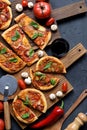 Flatlay of abundant vegetarian pizza party. Rustic homemade pizzas with mushrooms, tomatoes and basil served with wine and raw Royalty Free Stock Photo