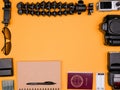 Flatlay accesories of a travel blogger on pastel orange background Royalty Free Stock Photo