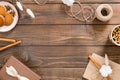 Flatlay autumn composition. Frame of cinnamon sticks, rope, envelope, cookies, tea cup, gift box on wooden background. Flat lay, Royalty Free Stock Photo