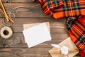 Flatlay autumn composition. Red women fashion scarf, letter, blank paper card mockup, rope, envelope, cinnamon sticks, cotton. Royalty Free Stock Photo