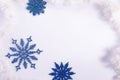 Flatlay blue christmas snowflakes on a white background. Copy space, new year minimalistic concept