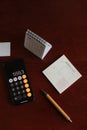 Flatlay of calculator on mobile phone, pen, calendar, planner, notepad on table background. Aesthetic home office desk Royalty Free Stock Photo