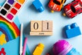 Flatlay calendar June 1, toys, paints, rainbow. World Conference on the Welfare of Children, World Children`s Day