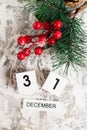 Flatlay, Christmas decoration and wooden calendar with date December 31 on light background, New Year. The concept of Royalty Free Stock Photo