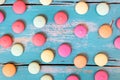 Flatlay, colorful cookies or macarons spread out of a blue wooden background