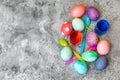 Flatlay, colorful dyed easter eggs, spoons and egg dyes on grey